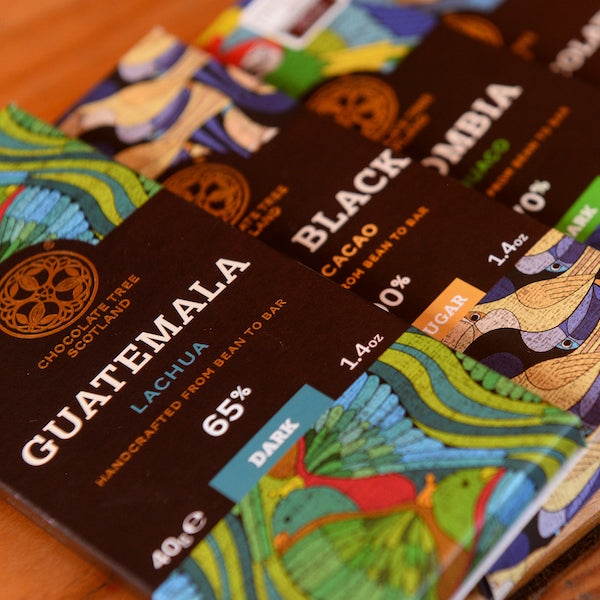 Closeup of several Chocolate Tree chocolate bars on a table at the Glen Lyon Coffee roastery cafe