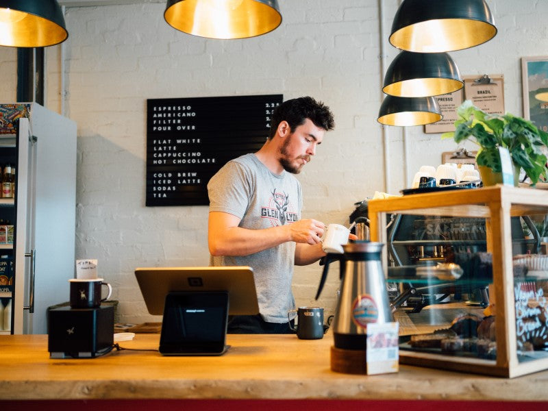 A barista working behind the bar at the Glen Lyon Coffee speciality roastery cafe
