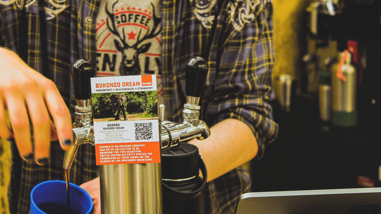 Close up of a barista dispensing nitro cold brew from a tap at the Glasgow Coffee Festival 2023