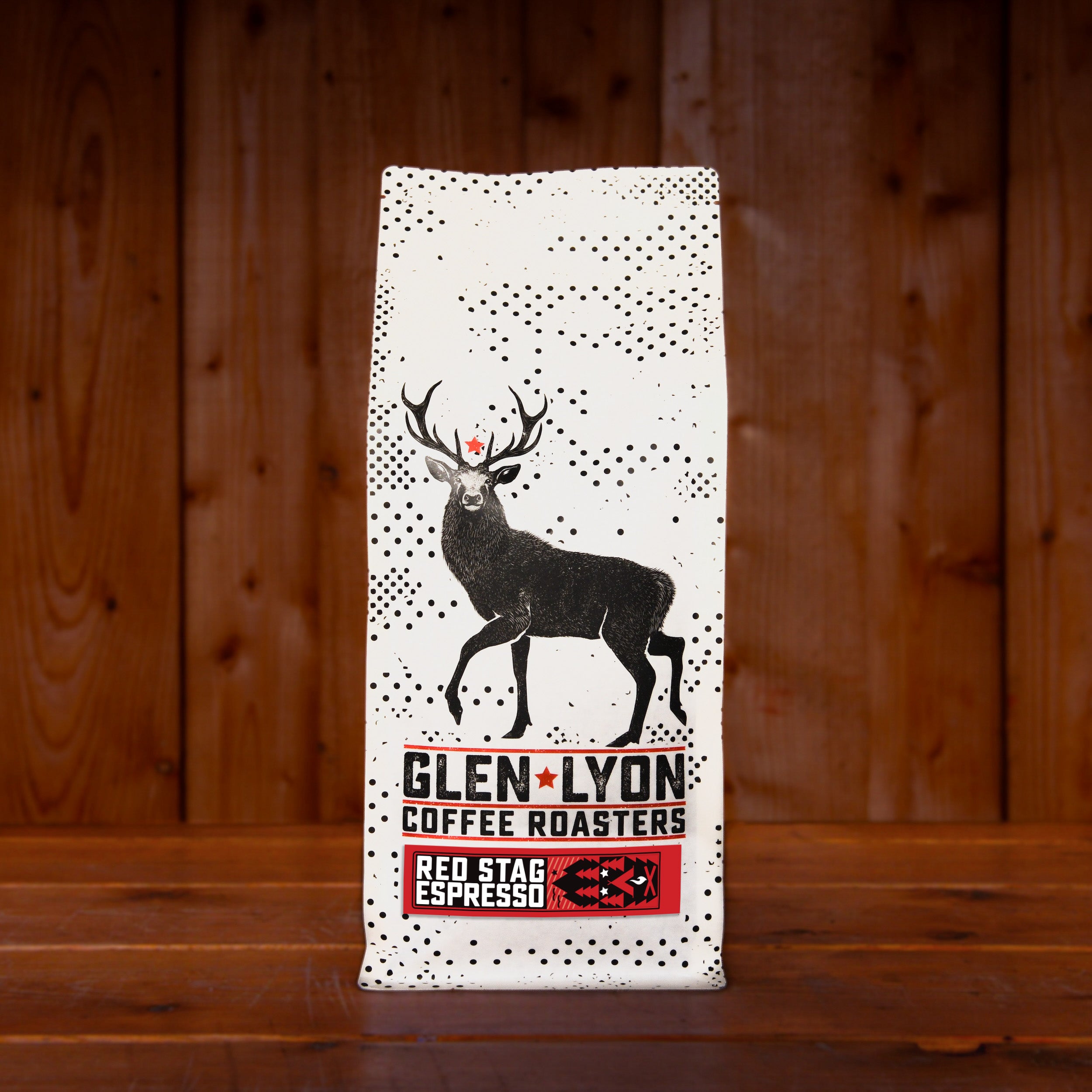 A 1kg bag of Glen Lyon Coffee Roasters' Red Stag Espresso speciality coffee sitting on a wooden table