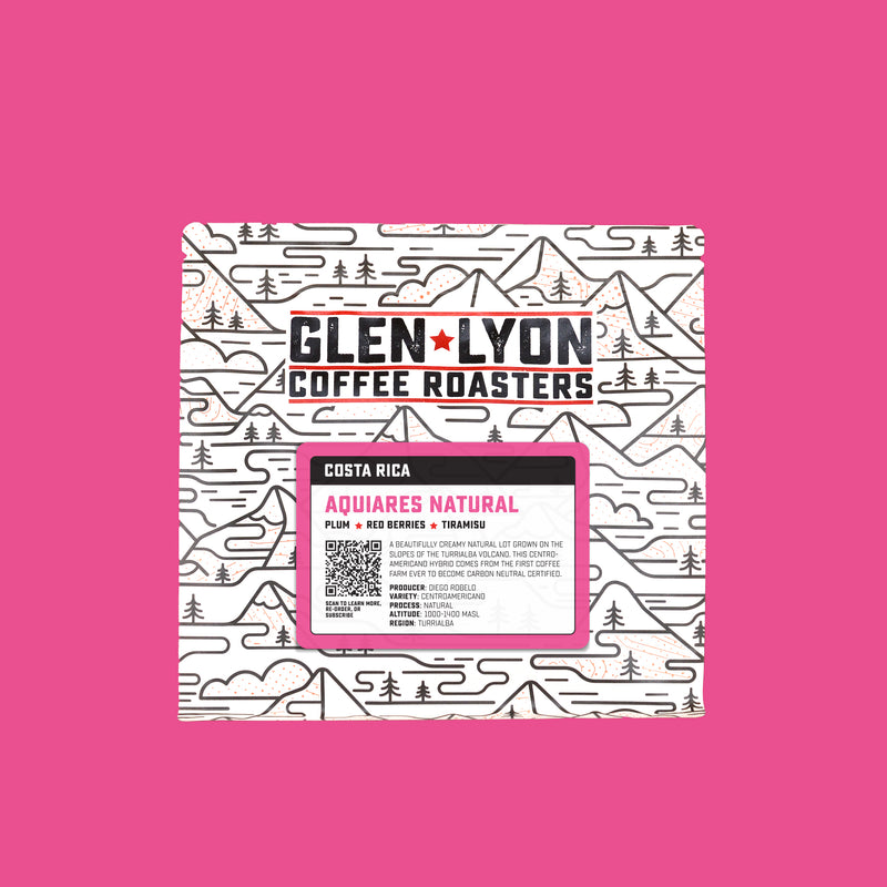 A 250g bag of Aquiares Natural from Glen Lyon Coffee Roasters coffee with a coloured pink background which matches the label.