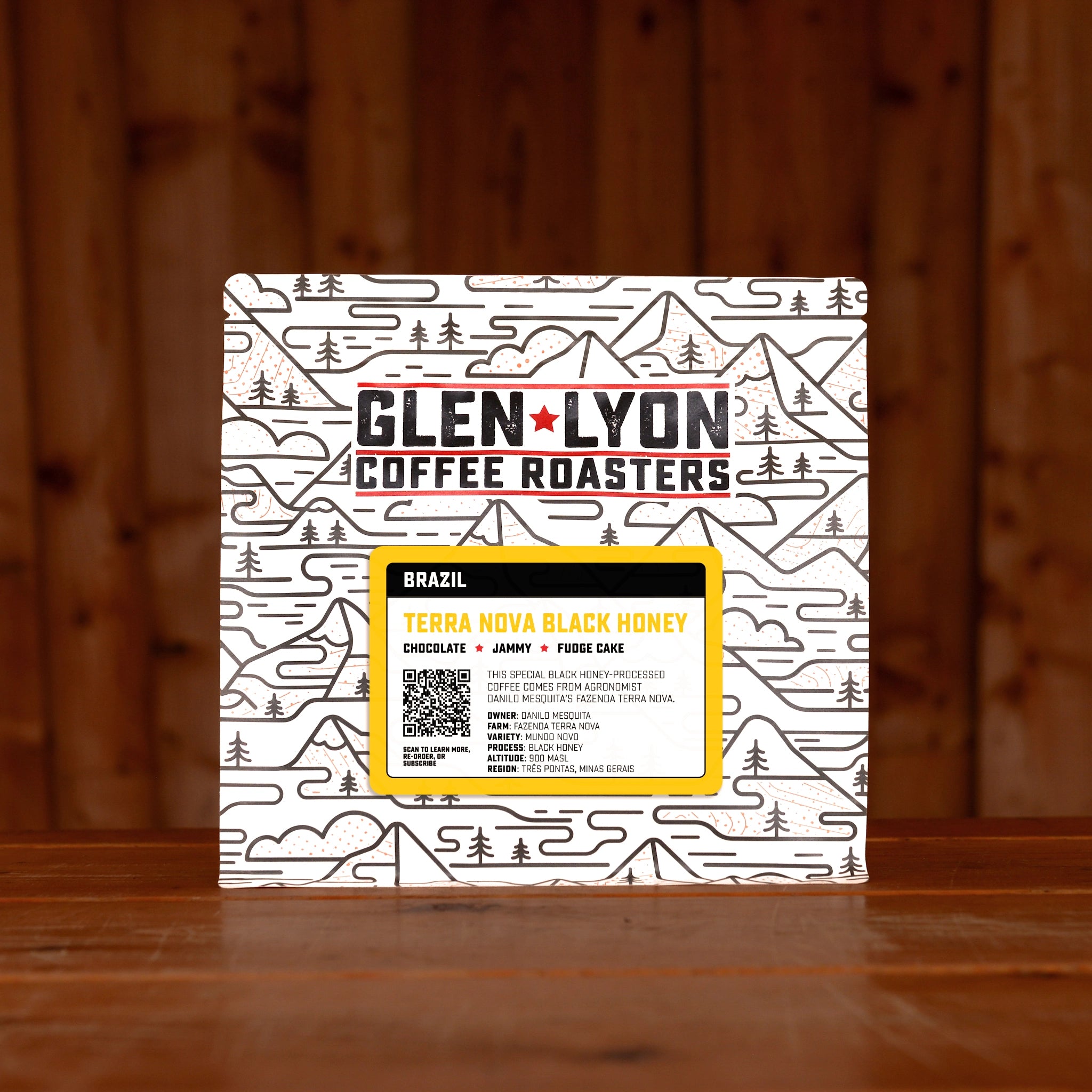 A 250g bag of Brazil Fazenda Terra Nova speciality coffee from Glen Lyon Coffee Roasters sitting on a wooden table.
