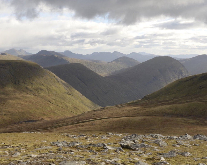 A landscape shot of the Scottish Highlands with mountains stretching to the horizon