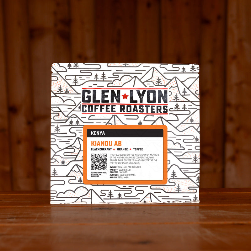 A 250g bag of Kiandu AB from Glen Lyon Coffee Roasters coffee sits on a wooden table with a slatted wood background.
