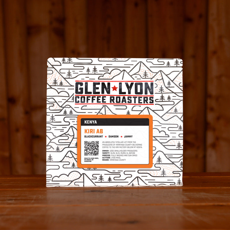 A 250g bag of Kiri AB from Glen Lyon Coffee Roasters coffee sits on a wooden table with a slatted wood background.