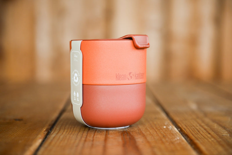 The red Lowball tumbler has a two-tone finish. The bottom and lid are a deeper red and the top of the cup is orangish-red.