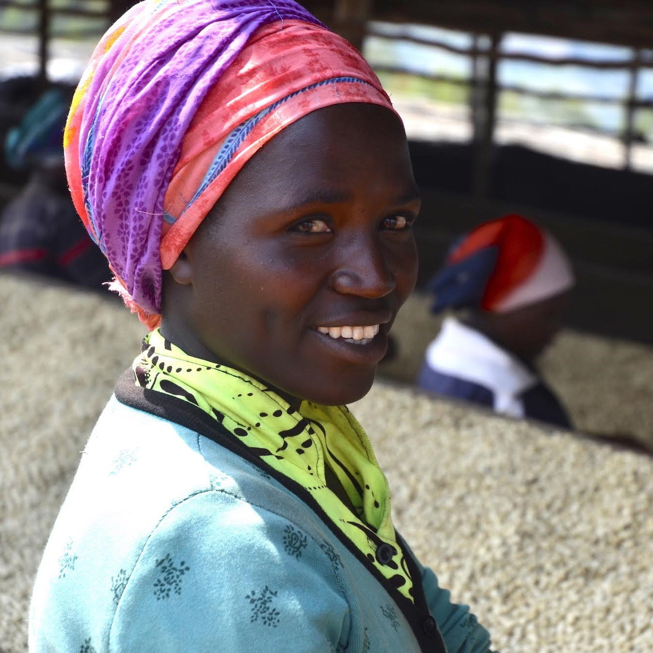 Close up of a coffee worker smiling at the camera at a washing station in Rwanda
