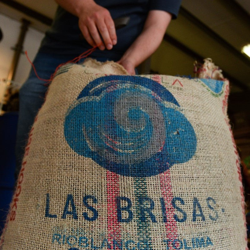 Low angle shot of a bag of green coffee, Las Brisas, being opened at the Glen Lyon Coffee roastery