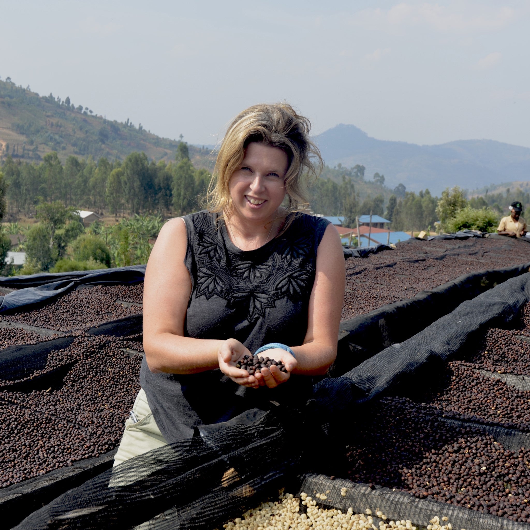 Glen Lyon Coffee Roasters' founder Fiona Grant holding up speciality coffee beans at a washing station in Kenya